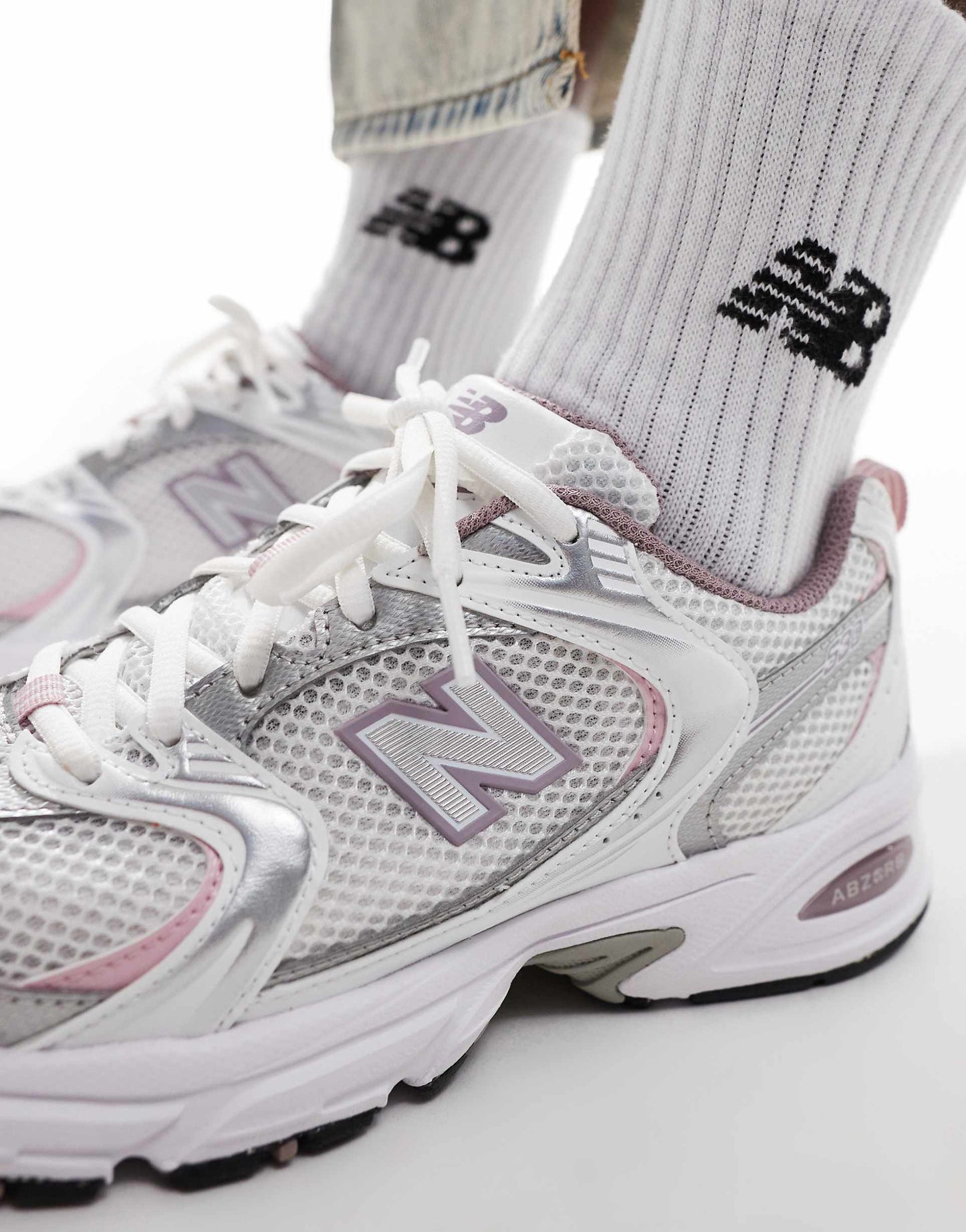 New Balance 530 trainers in white with pink details