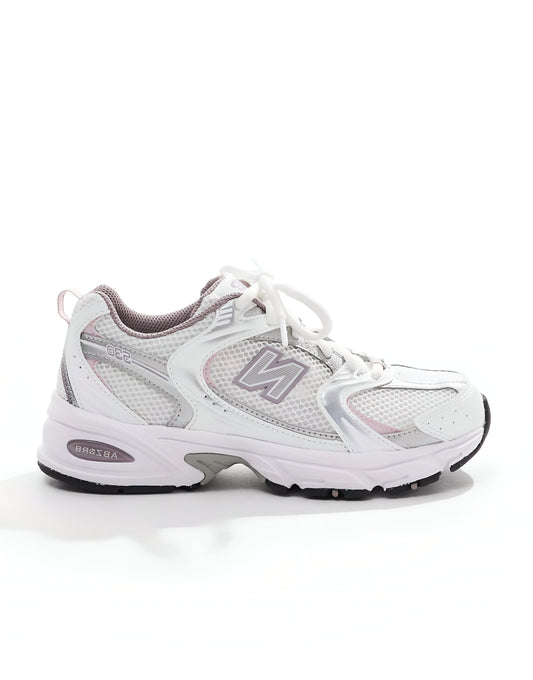New Balance 530 trainers in white with pink details